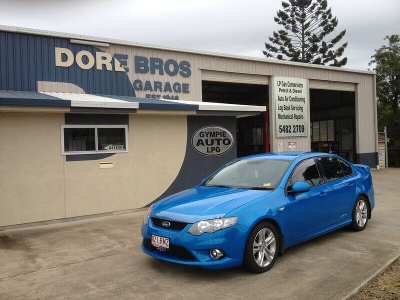 A Blue Car is Parked in Front of the Dorz Bros Garage