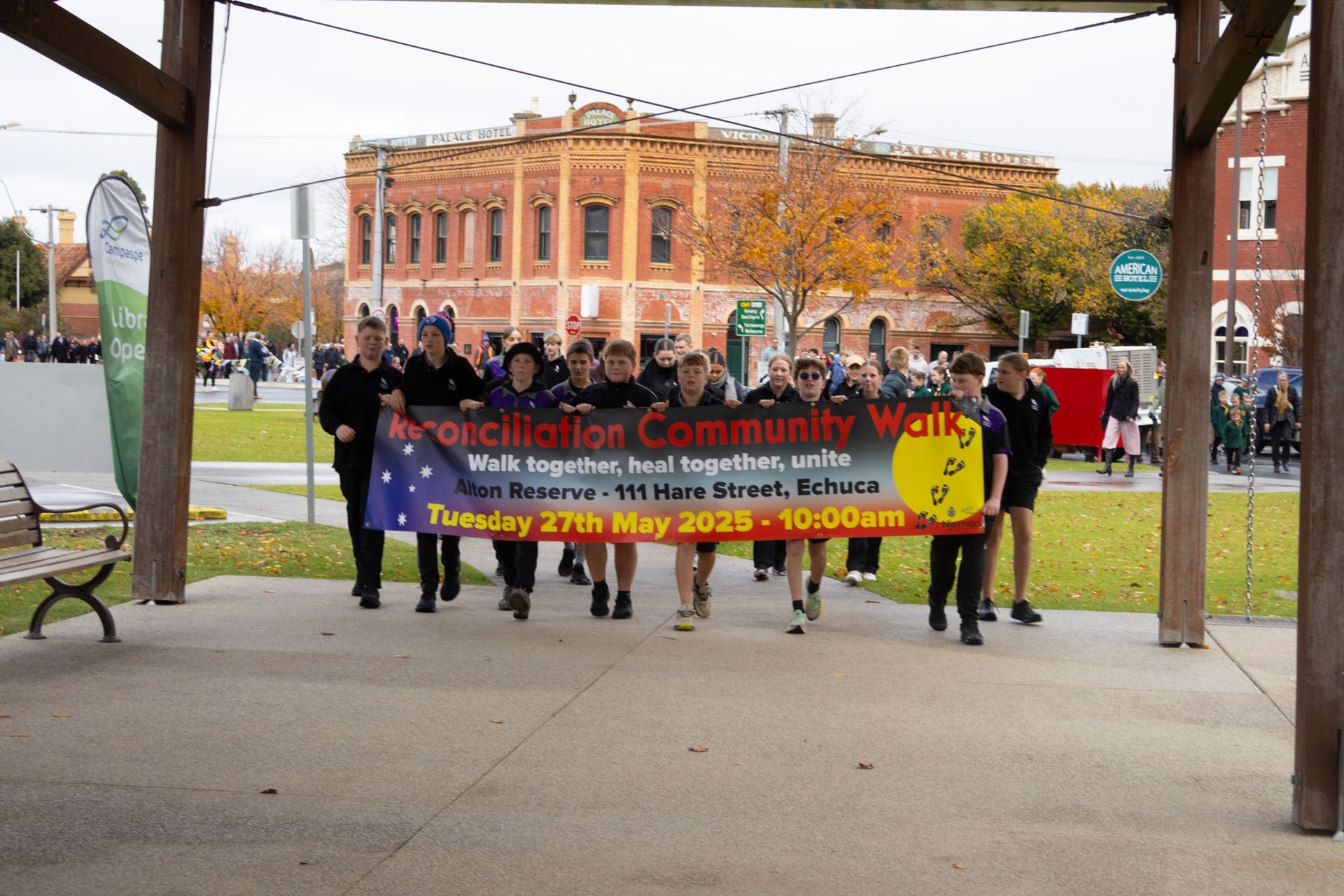 Group marching with banner reading 