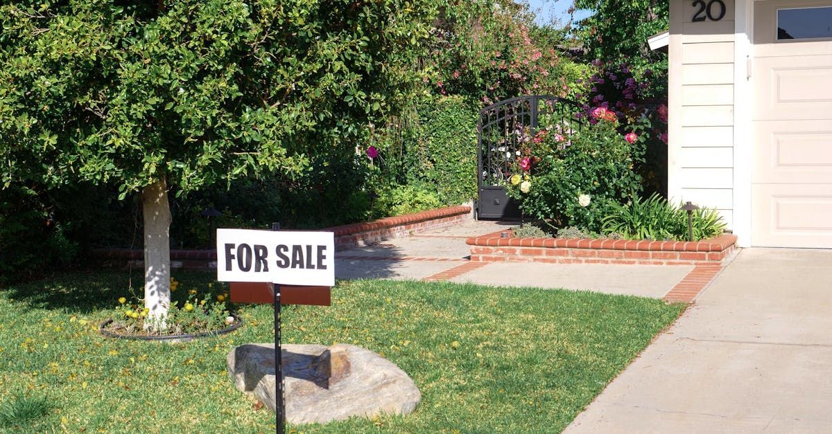 A for sale sign is in front of a house