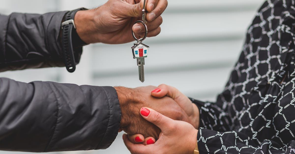 A man is handing a woman a set of keys.