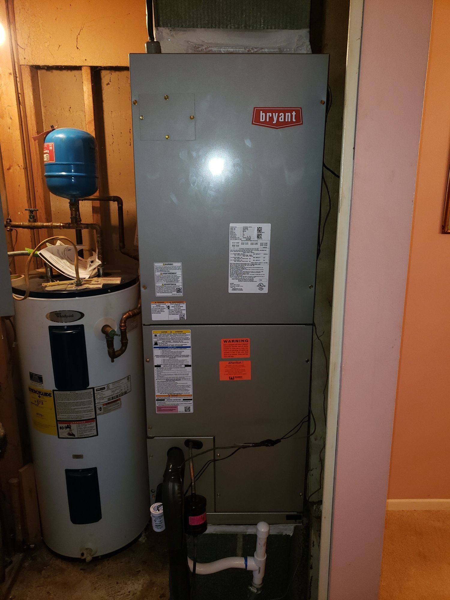 A room with a heater and a water heater in it.