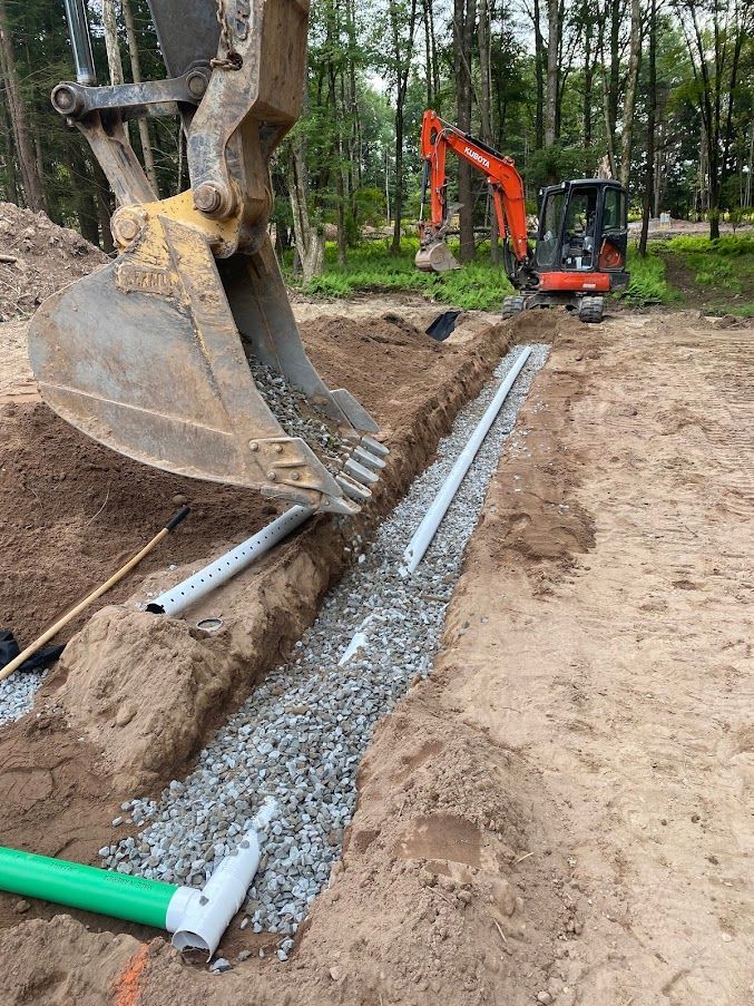 A bulldozer is digging a trench in the dirt.