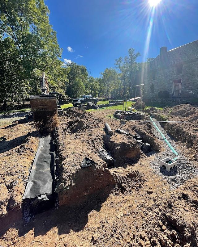 A drainage system is being installed in a backyard.