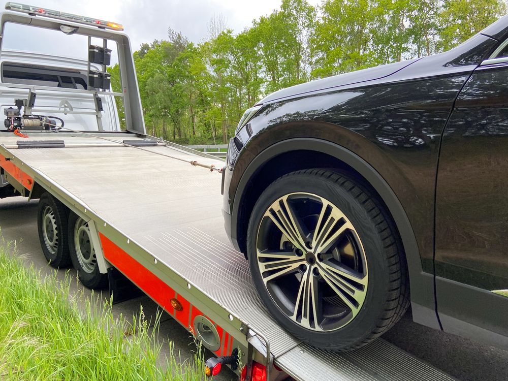 Black Suv Being Towed on a Flatbed Tow Truck — Best Price Towing in Bateau Bay, NSW