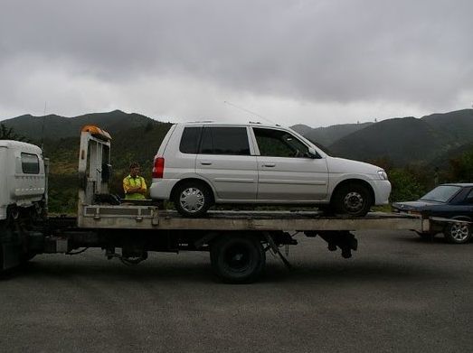 White Minivan on a Tow Truck — Best Price Towing in Cessnock, NSW