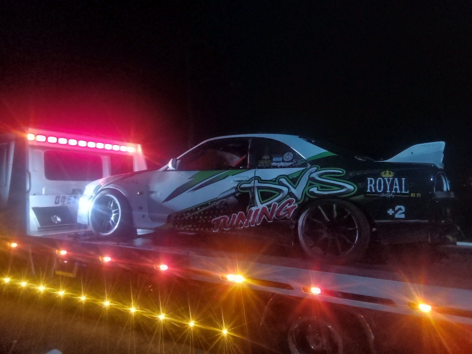 Race Car on Tow Truck at Night with Flashing Lights — Best Price Towing in Woongarrah, NSW