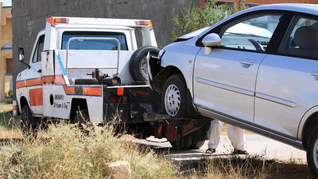 Tow Truck Towing a Damaged Car on a Roadside — Best Price Towing in Woongarrah, NSW