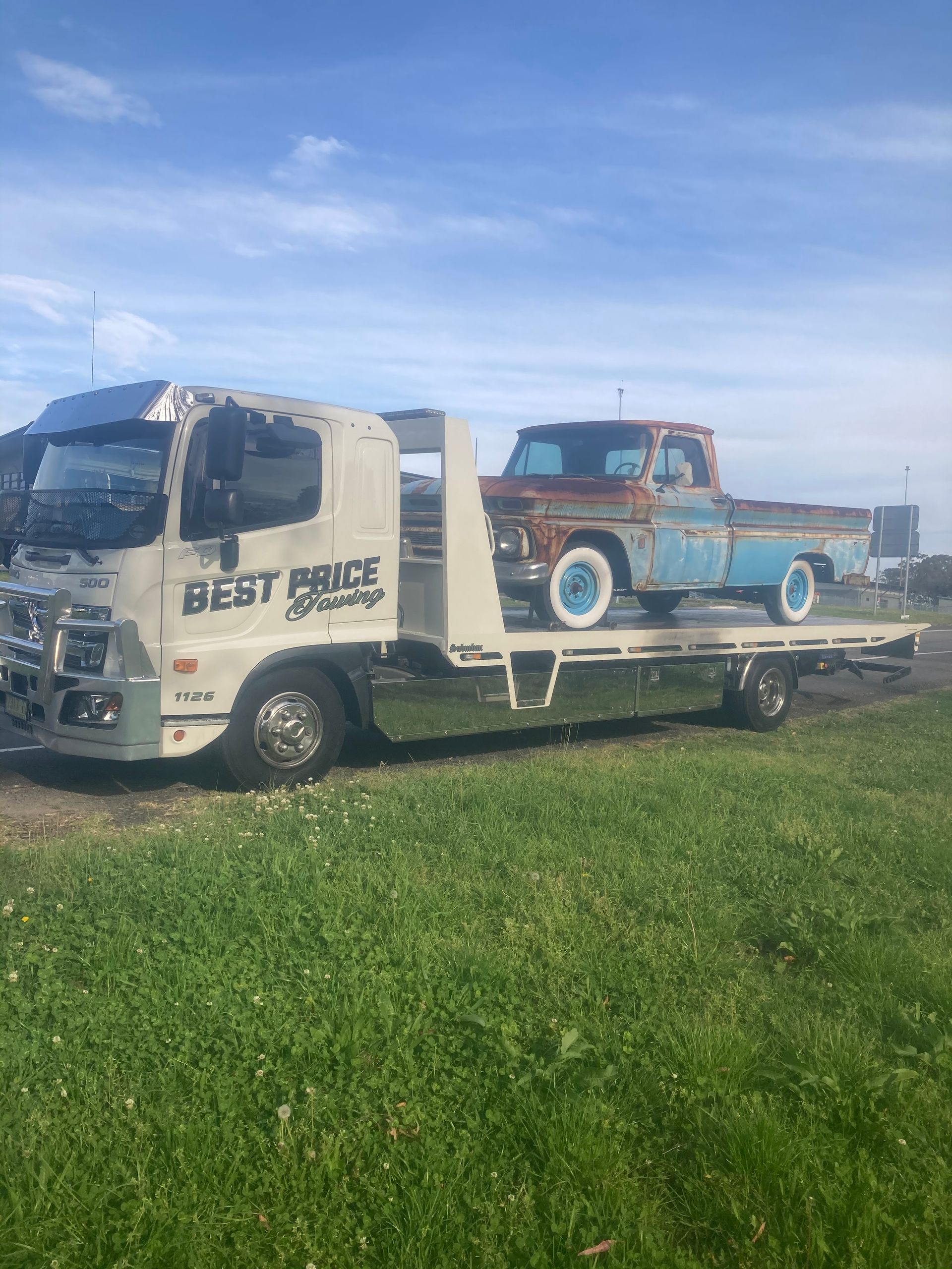 Tow Truck with an Old, Rusted Pickup Truck on its Flatbed — Best Price Towing in Woongarrah, NSW