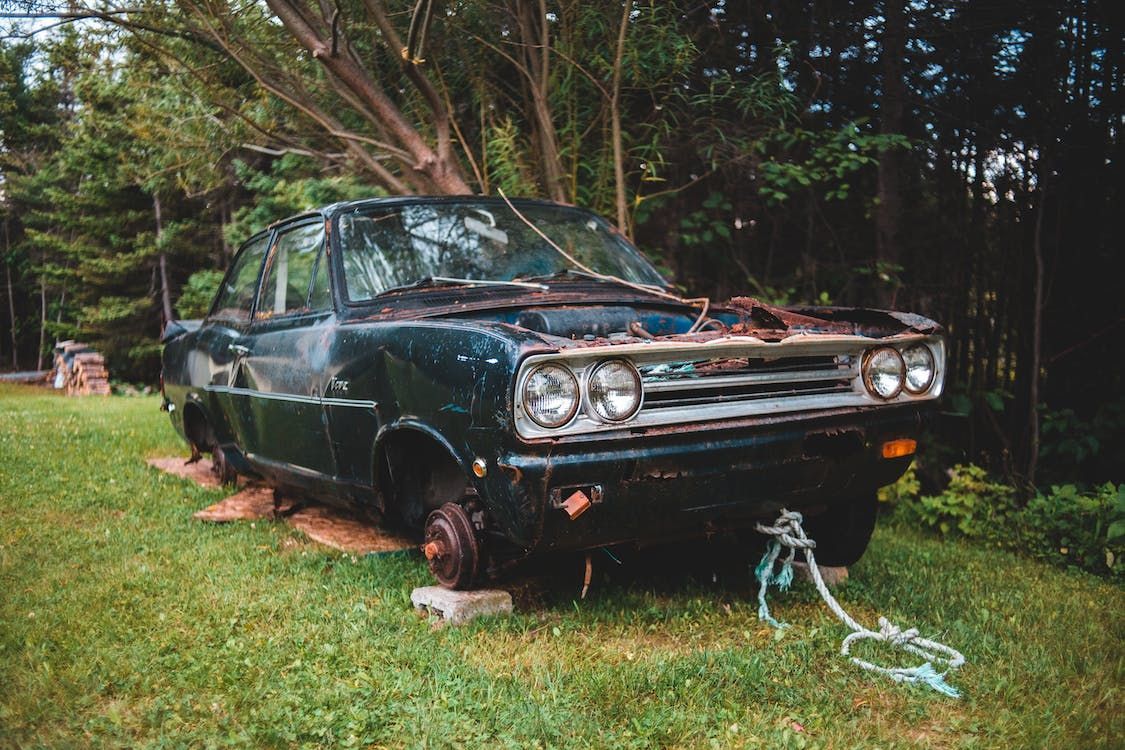 Car Sits on Blocks in a Grassy Yard — Best Price Towing in Morisset, NSW