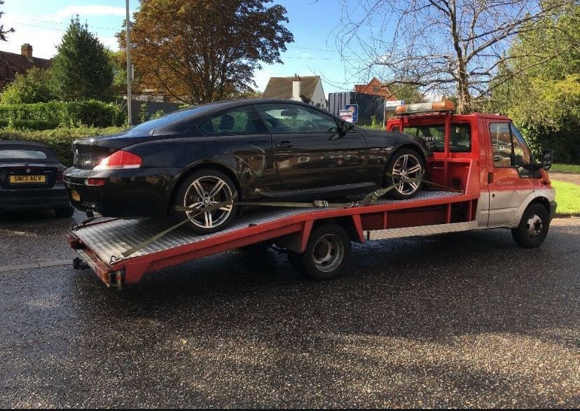 Black Car on a Red Tow Truck — Best Price Towing in Cessnock, NSW