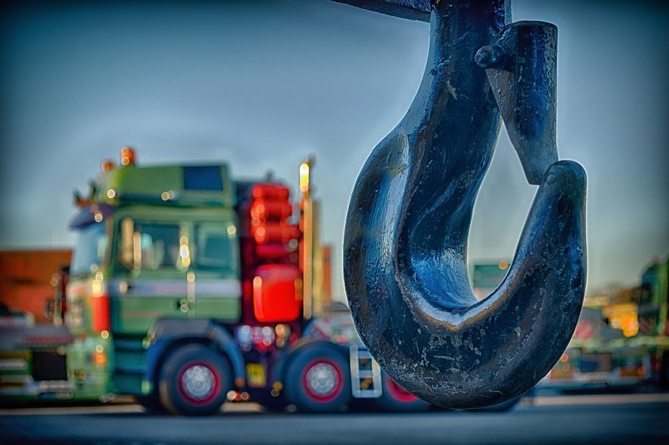 Large, Dark Crane Hook With a Green and Red Semi-truck — Best Price Towing in Wyee, NSW