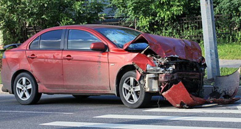 Red Car Crashed Into a Utility Pole on a City Street — Best Price Towing in Woongarrah, NSW