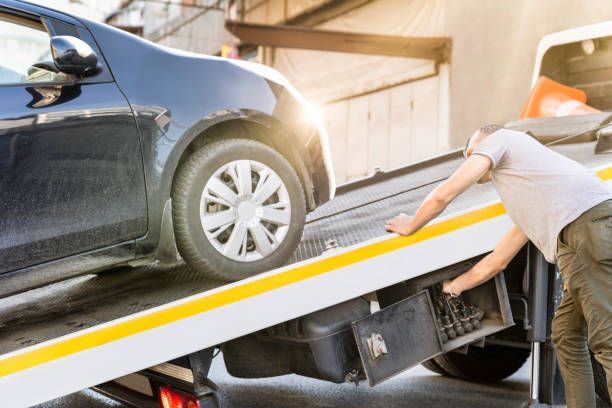 Tow Truck Loading a Dark Blue Car — Best Price Towing in Wyee, NSW