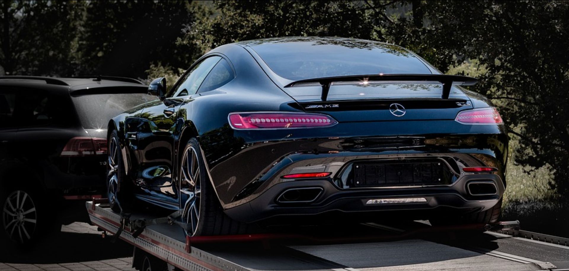 Black Mercedes Being Transported on a Flatbed Tow Truck — Best Price Towing in Budgewoi, NSW