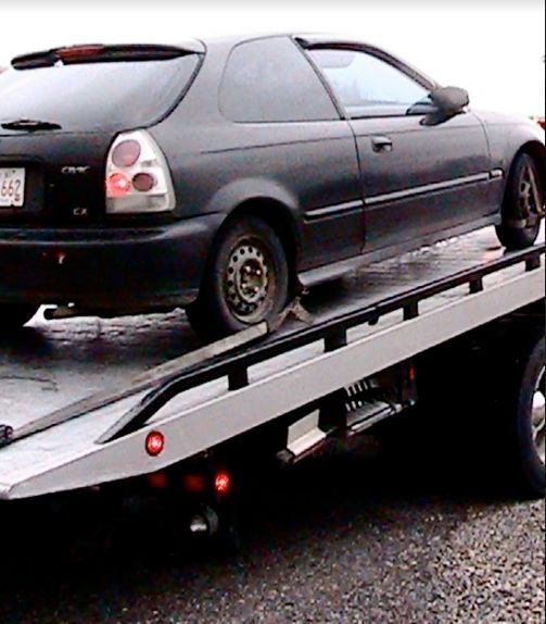 Black Honda Civic Being Towed on a Flatbed Tow Truck — Best Price Towing in Lake Macquarie, NSW
