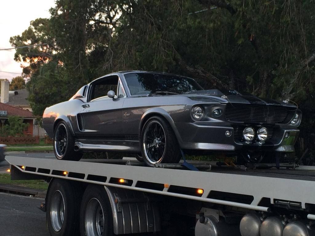 Gray Ford Mustang Shelby on a Flatbed Tow Truck — Best Price Towing in Woongarrah, NSW