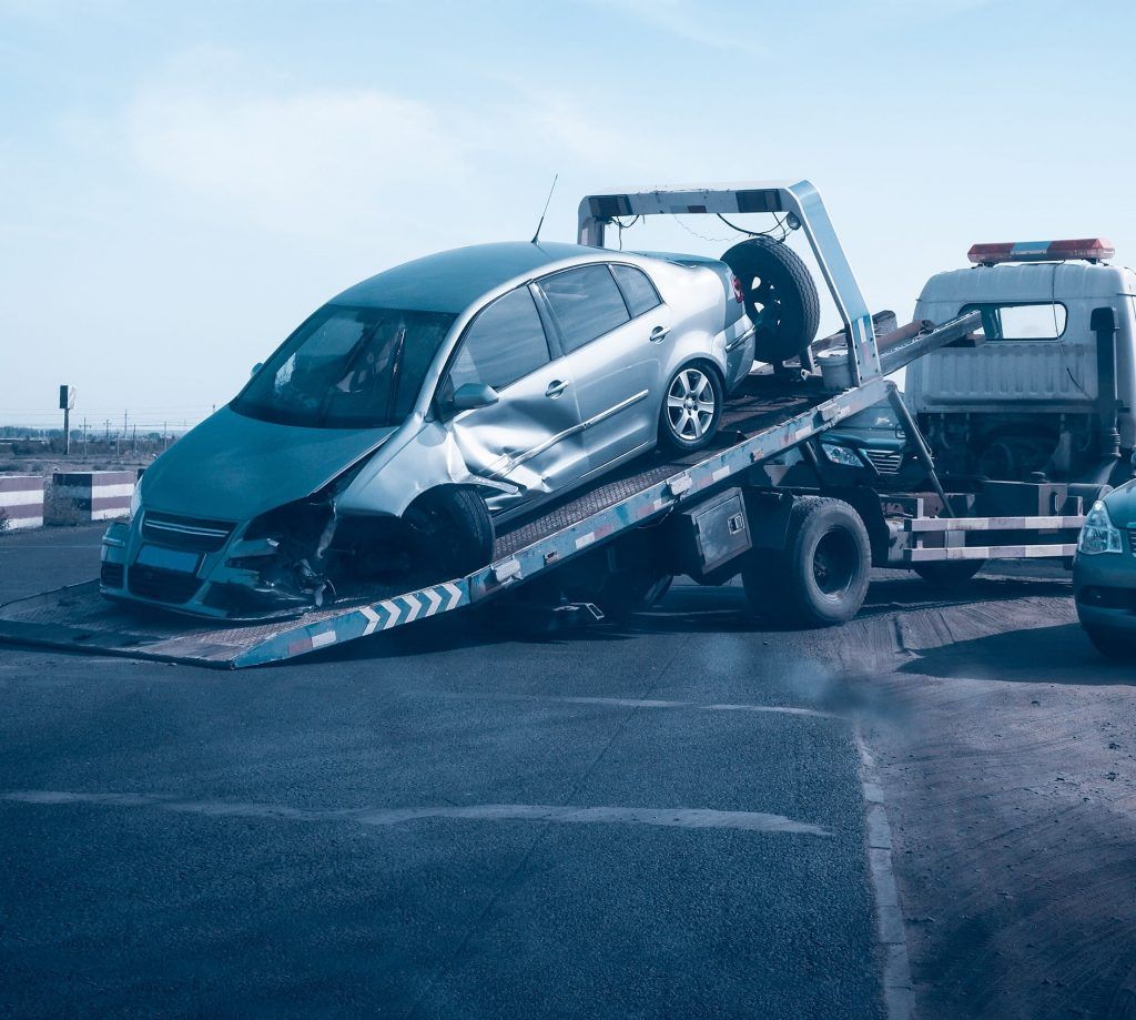 Damaged Silver Car on a Tow Truck After a Collision — Best Price Towing in Woongarrah, NSW