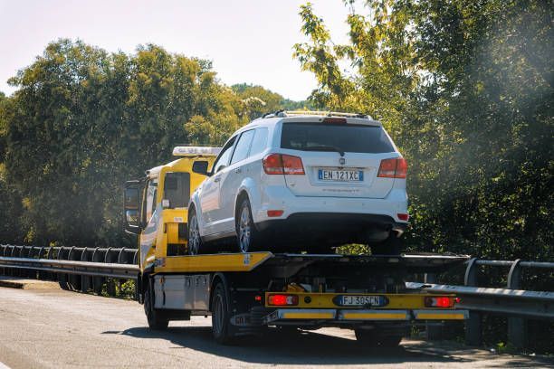 White Car Being Towed on a Yellow Tow Truck — Best Price Towing in Woongarrah, NSW