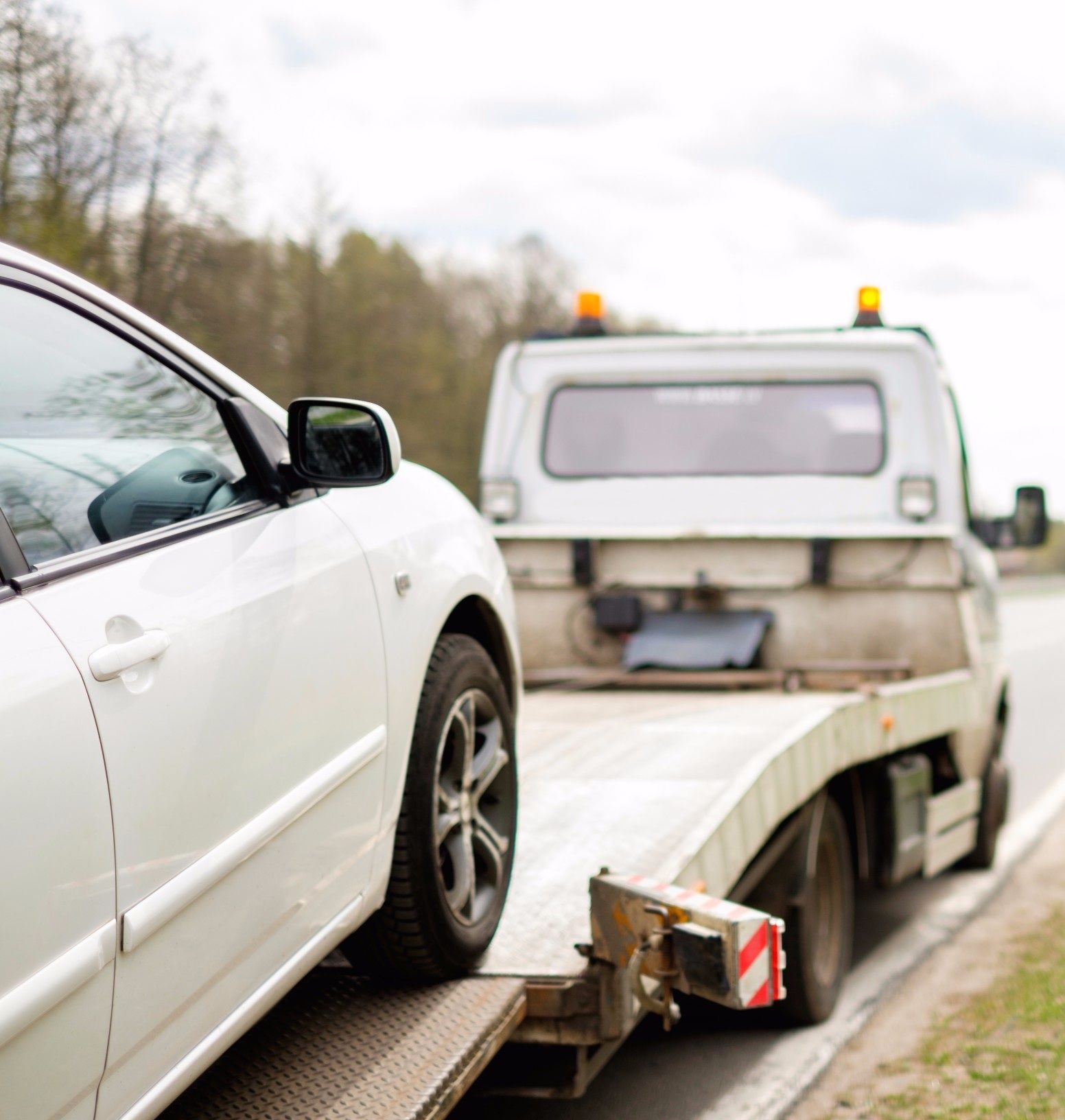 White Car Being Towed by a Tow Truck — Best Price Towing in Woongarrah, NSW