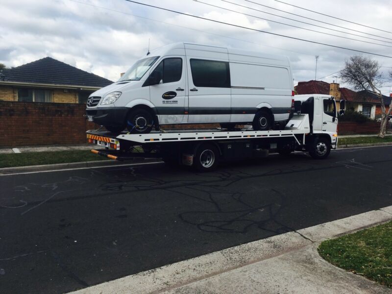 White Van Loaded Onto a Flatbed Tow Truck — Best Price Towing in Cessnock, NSW
