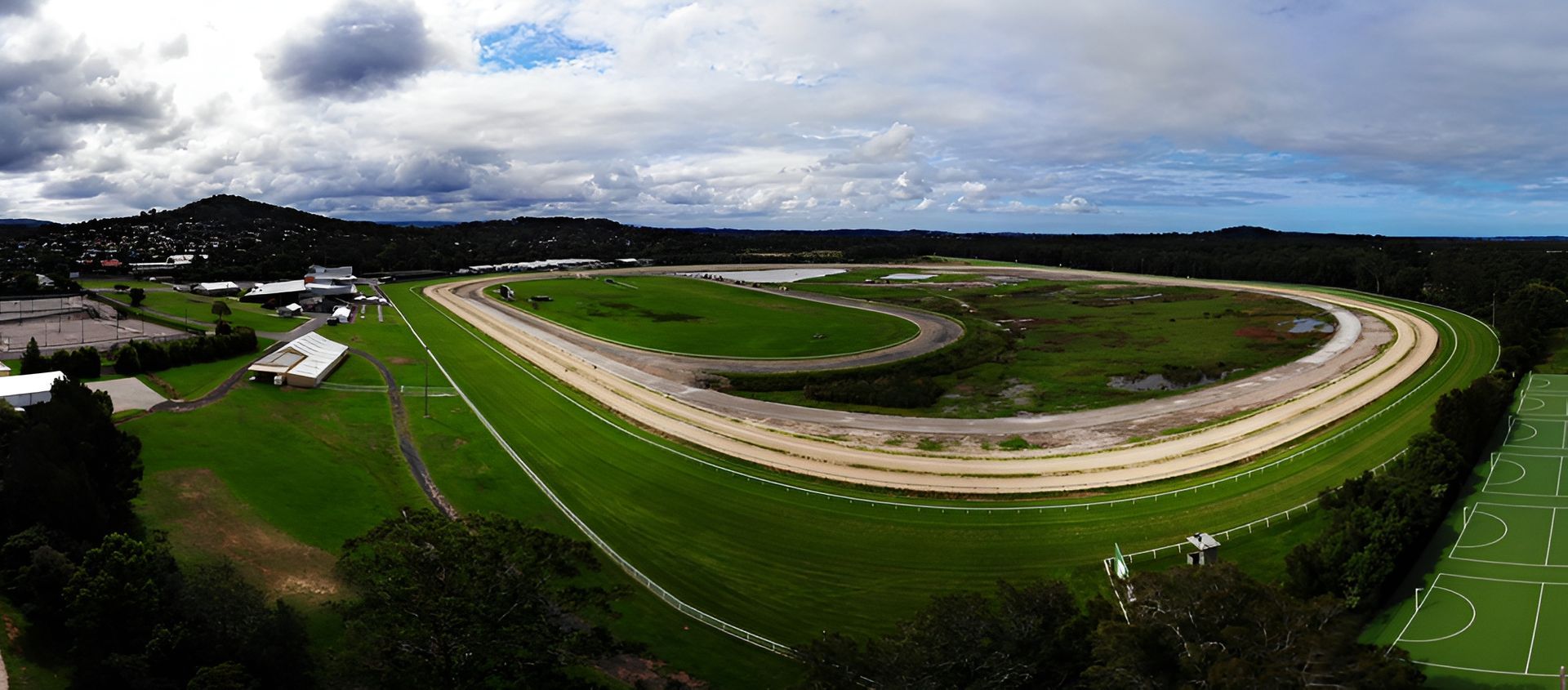 Aerial View of a Racetrack With a Dirt Track on Green Grass — Best Price Towing in Wyong, NSW