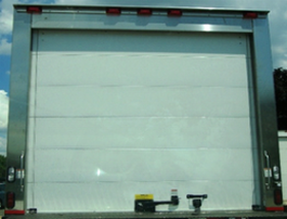 The back of a truck with a white garage door
