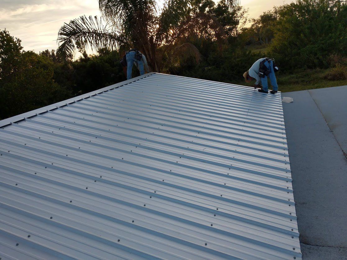 Workers fixing the roof - Sebring, FL - Robert E White II Inc