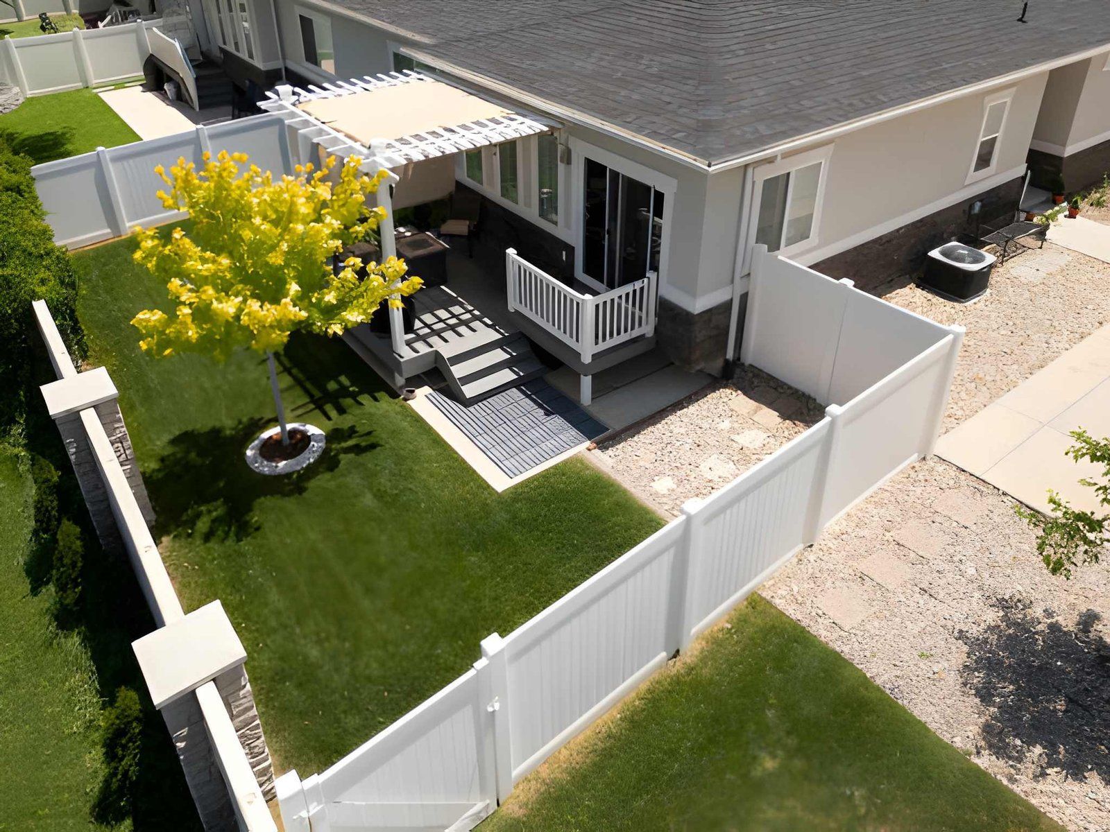 Aerial view of a white vinyl backyard privacy fence.