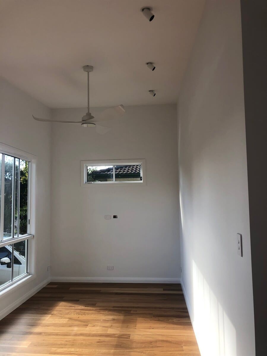 An Empty Room With A Ceiling Fan And A Window — L.A.F Electrical P/L In Gosford, NSW