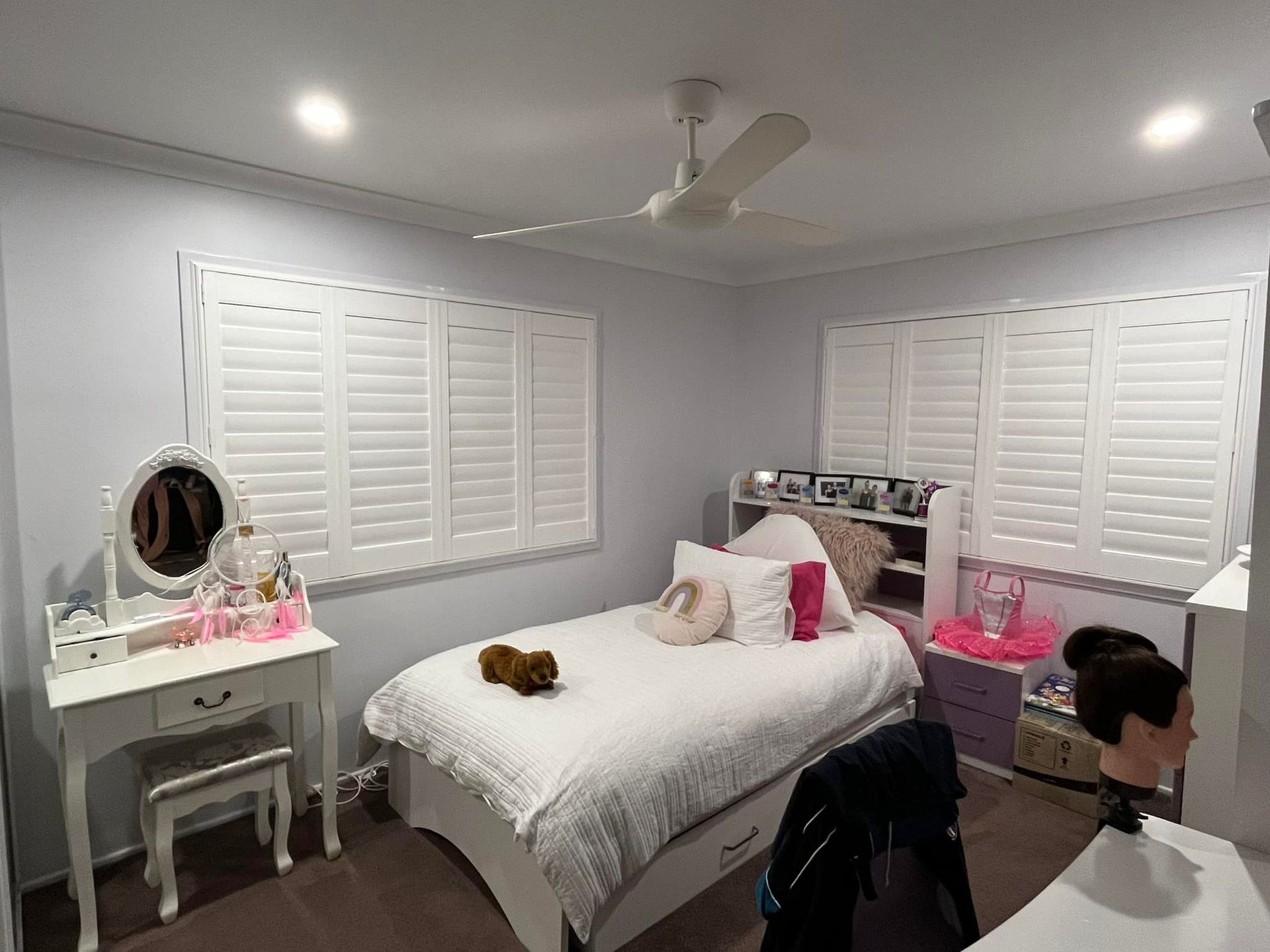 A Bedroom With a Bed , Dresser , Mirror and Ceiling Fan — Whitsunday Blinds & Security In Beaconsfield, QLD