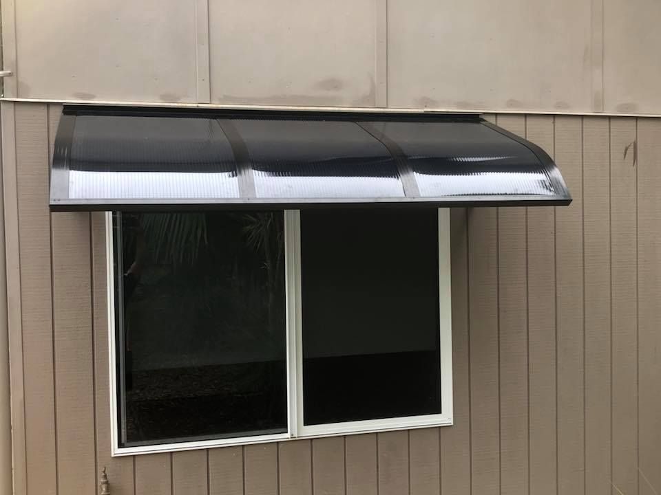 A Window With a Canopy Over It is on a House — Whitsunday Blinds & Security In Beaconsfield, QLD