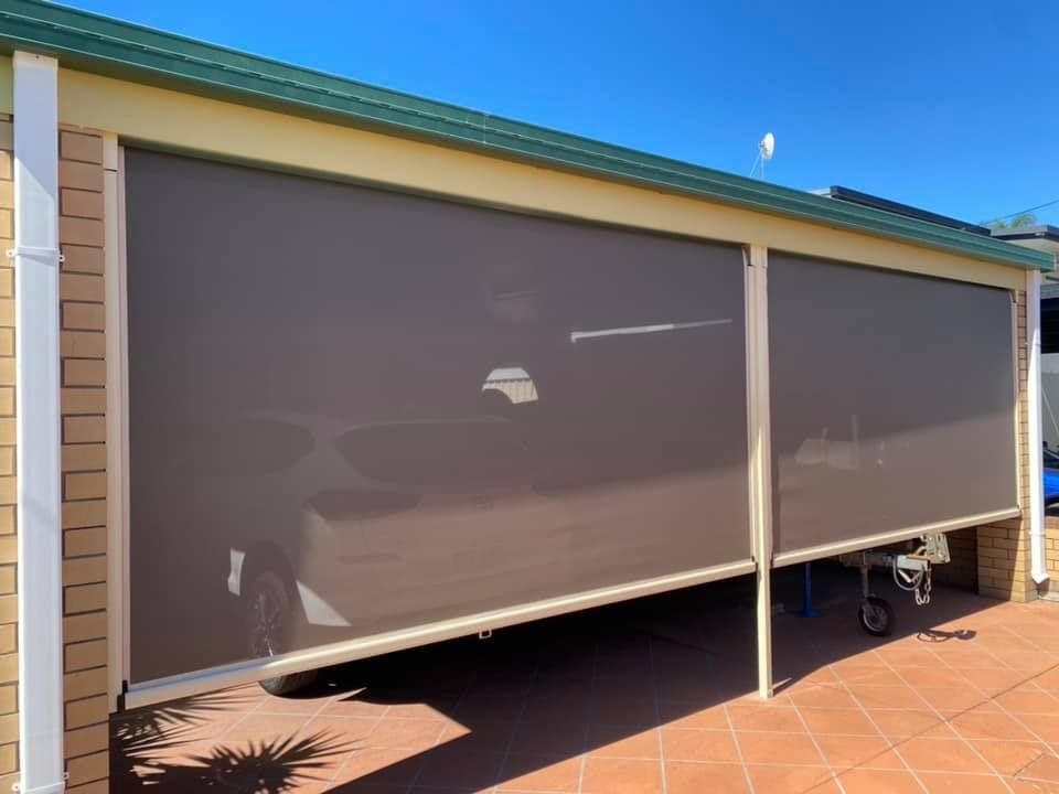 A Car is Parked Under a Roof With a Screen — Whitsunday Blinds & Security In Beaconsfield, QLD