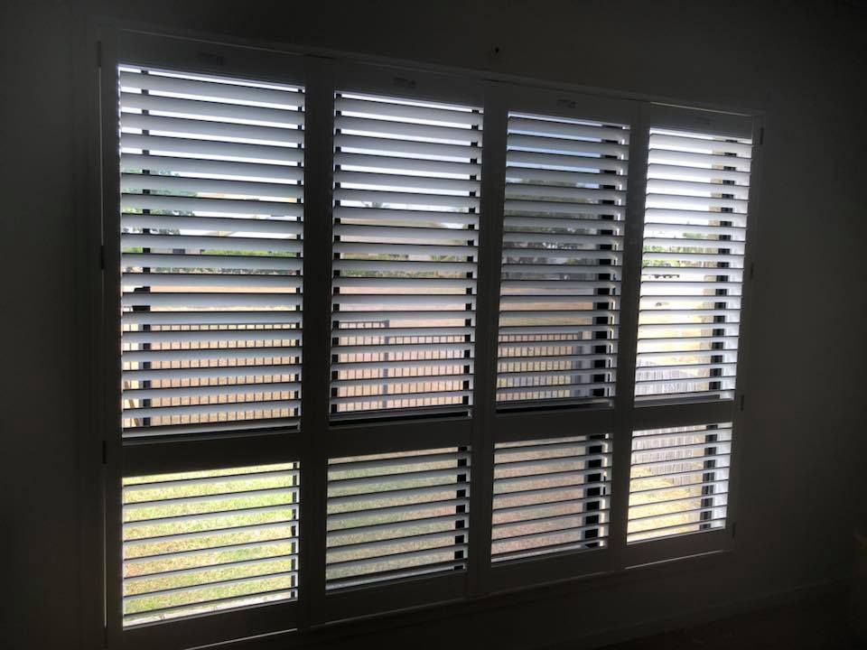 A Large Window With Shutters on It in a Room — Whitsunday Blinds & Security in Airlie Beach, QLD