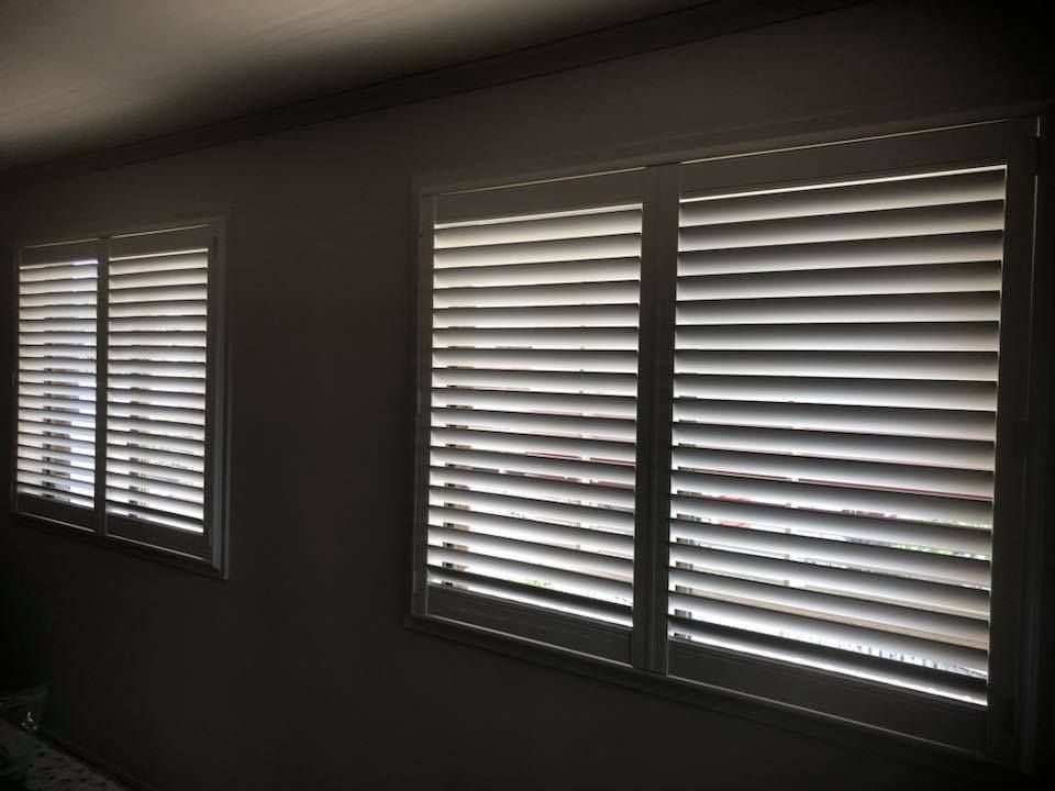 A Room With Three Windows With White Shutters on Them — Whitsunday Blinds & Security in Airlie Beach, QLD