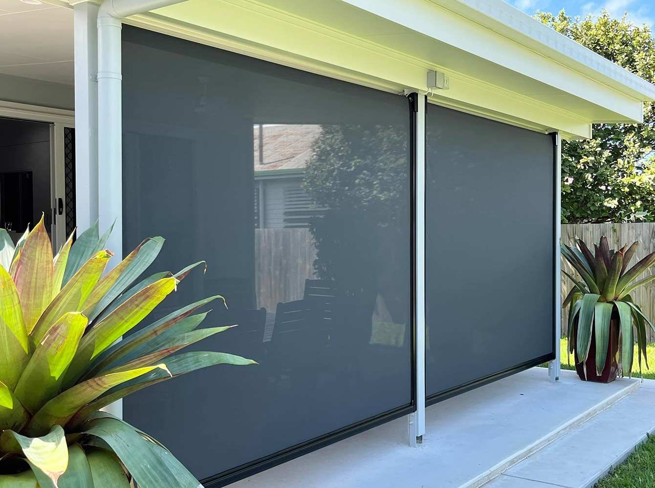 A Patio With a Screen on the Side of It and a Potted Plant — Whitsunday Blinds & Security In Beaconsfield, QLD