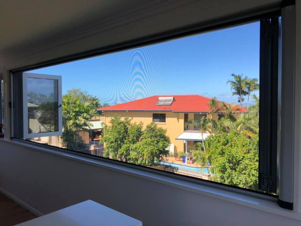 A Large Window With a View of a House and a Pool — Whitsunday Blinds & Security In Beaconsfield, QLD