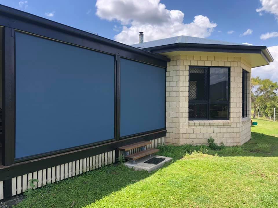 A House With a Blue Screen on the Side of It — Whitsunday Blinds & Security In Beaconsfield, QLD