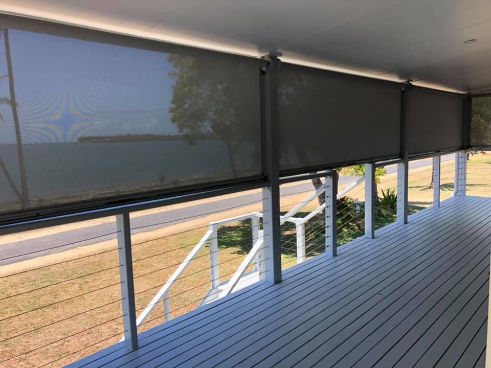 A Balcony With a View of a Field and a Road — Whitsunday Blinds & Security In Beaconsfield, QLD