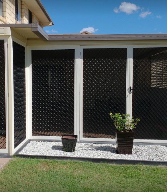 A White Door With a Black Pattern Screen — Whitsunday Blinds & Security In Beaconsfield, QLD
