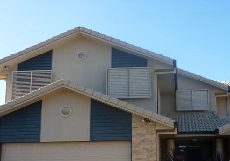 A Large House With a Garage and a Blue Roof — Whitsunday Blinds & Security In Beaconsfield, QLD