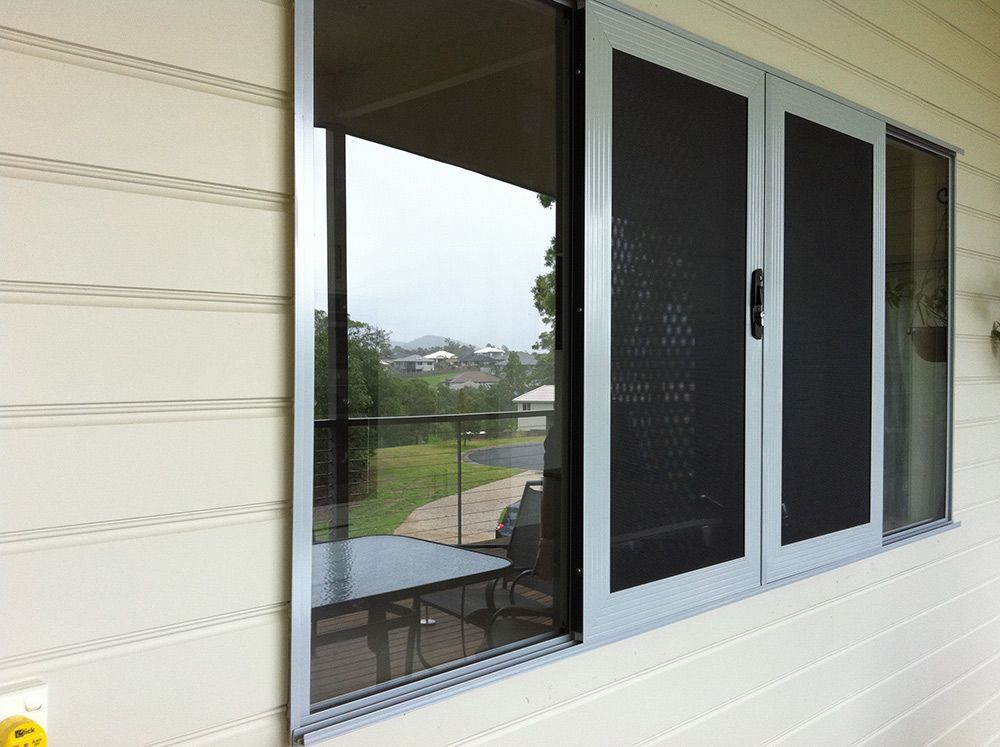 House With a Sliding Glass Window With Security Screen — Whitsunday Blinds & Security In Beaconsfield, QLD