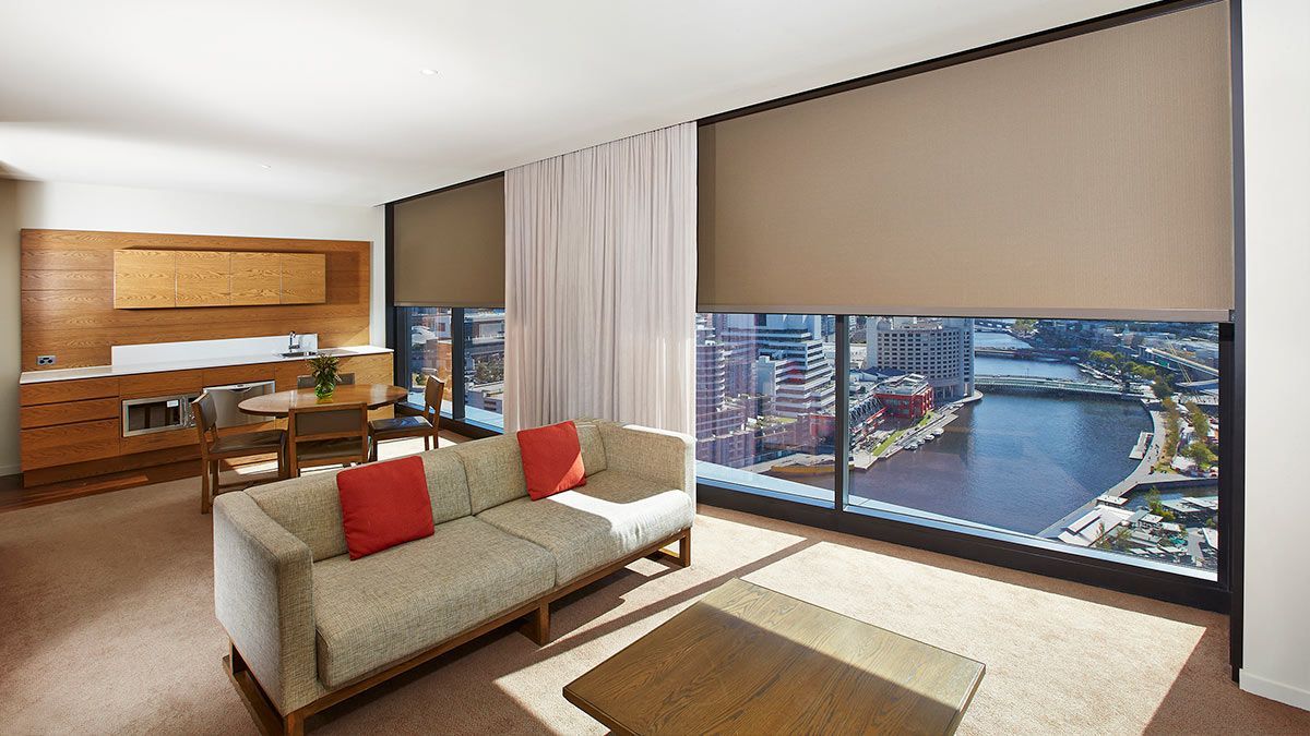 Highrise Apartment with a Couch and Blockout Blinds — Whitsunday Blinds & Security In Beaconsfield, QLD