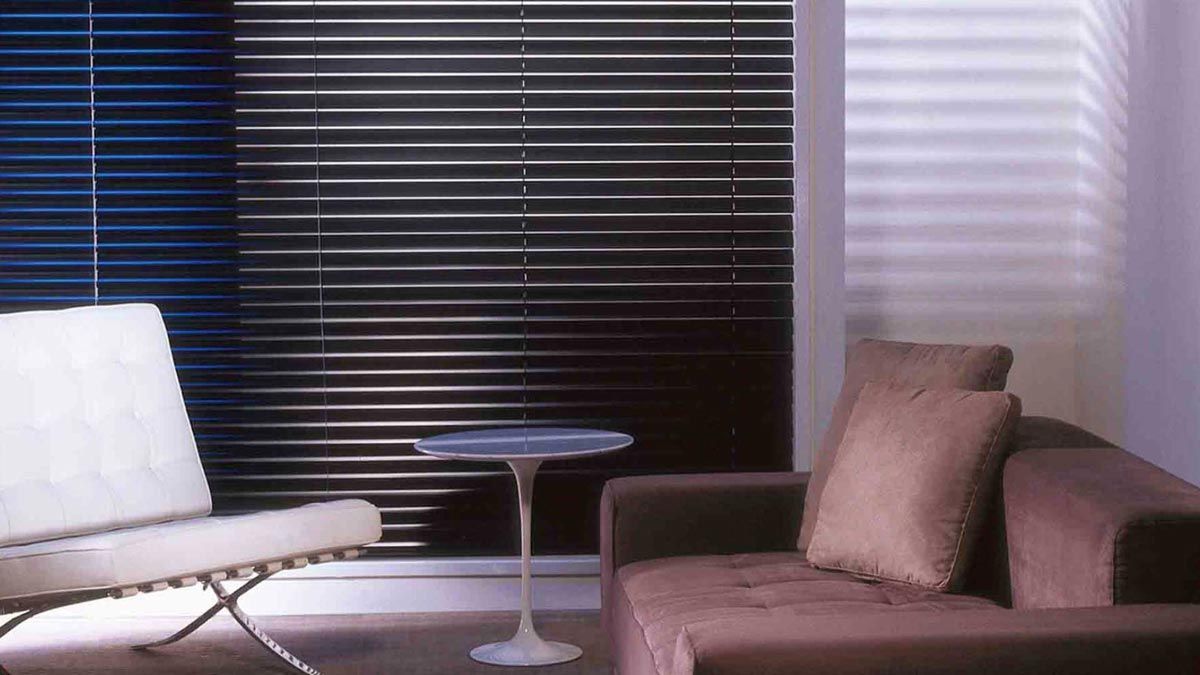 Black Shutters with Couch and Table — Whitsunday Blinds & Security In Beaconsfield, QLD