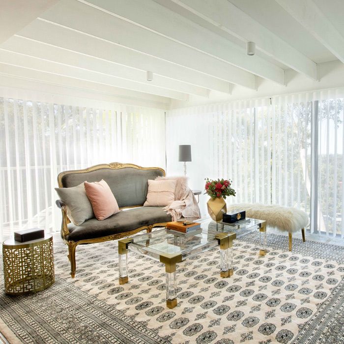 Living Room With a Couch With Large Vertical Blinds in The Window — Whitsunday Blinds & Security In Beaconsfield, QLD