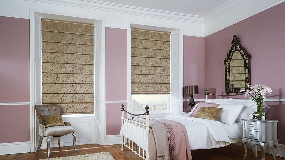 A Bedroom With Roman Blinds, Pink Walls, a Bed, a Chair, and a Mirror — Whitsunday Blinds & Security In Beaconsfield, QLD