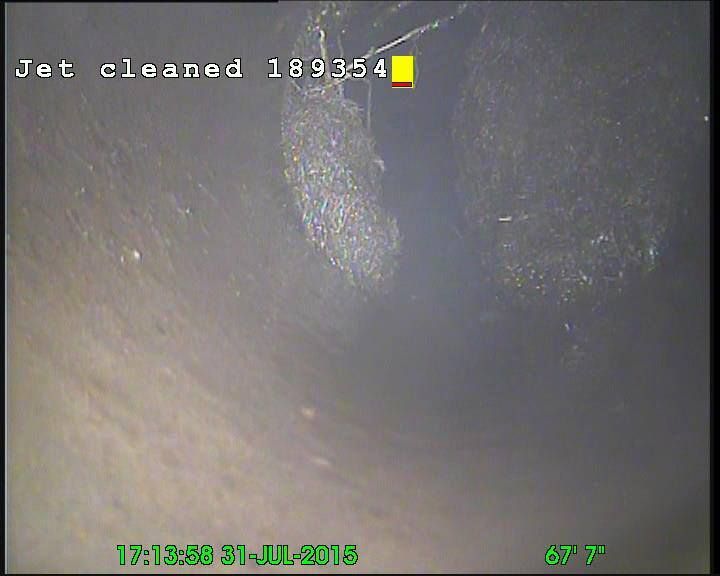 Inside view of a pipe after jet cleaning. Debris is visible, date/time stamp present.
