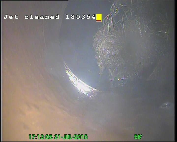 Inside a pipe, tangled debris near the top. The date 21-JUL-2015 and a time is visible.