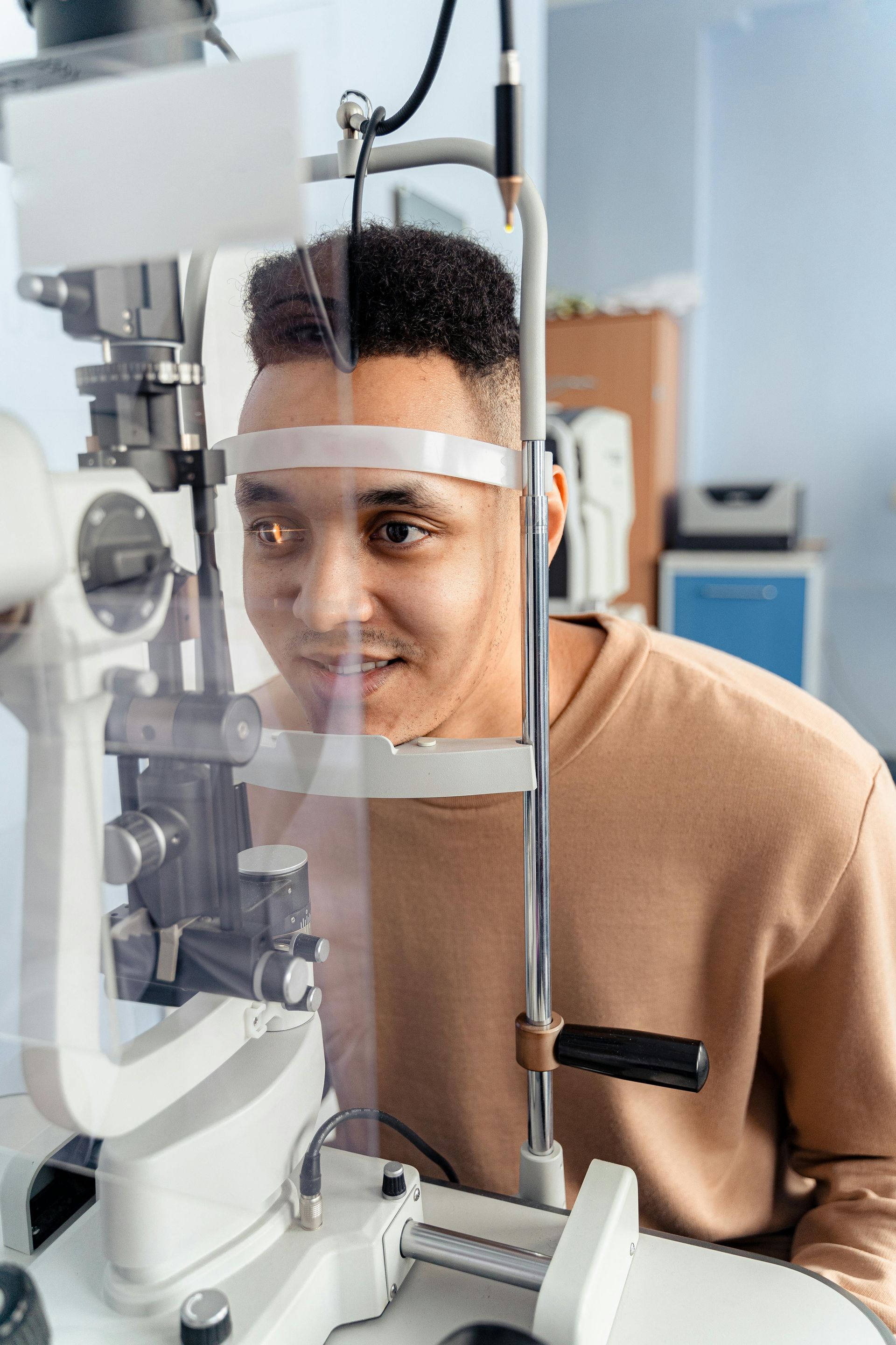 A man is getting his eyes examined by an ophthalmologist.
