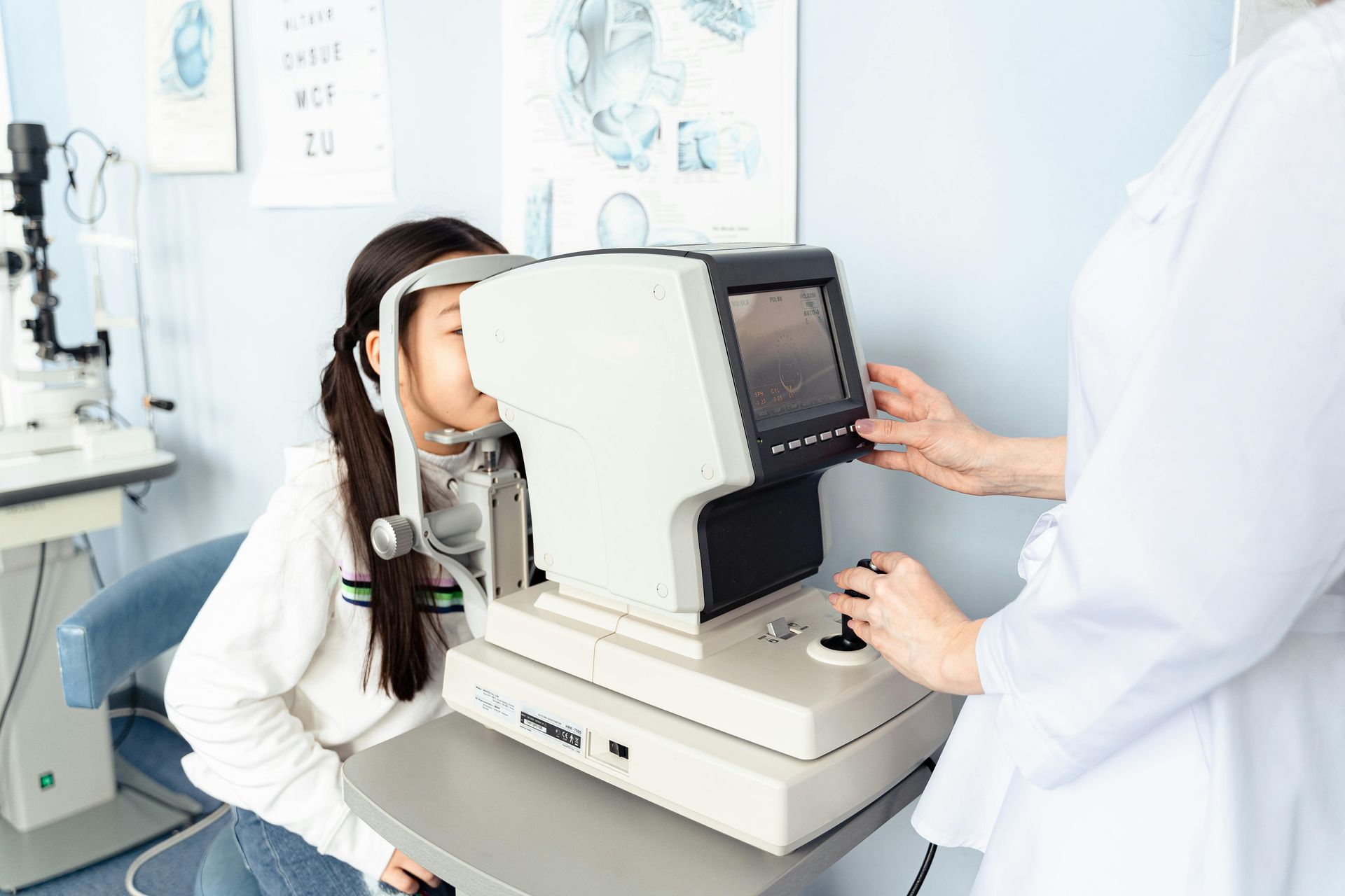 A woman is getting her eyes checked by an ophthalmologist.