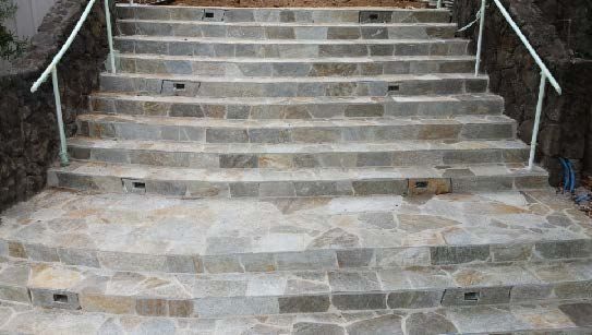Stone steps with handrails leading upwards.